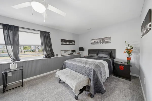 a bedroom with a bed and a window