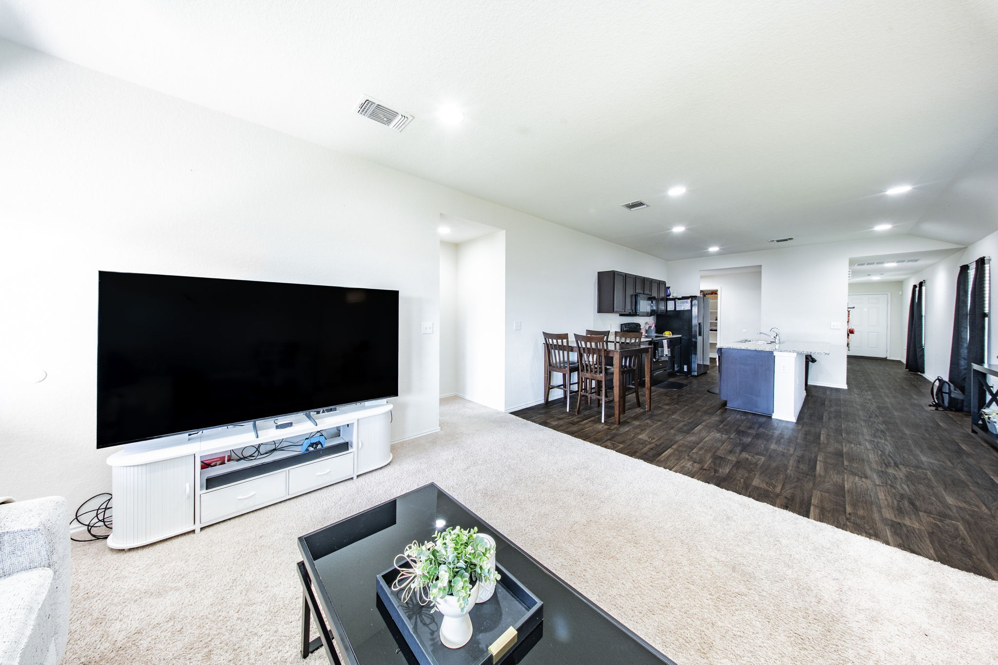 14903 Tuff Road Manor, TX 78653 - Photo 24 of 25 An open floorplan seamlessly connects the living and dining areas, with recessed lighting throughout.