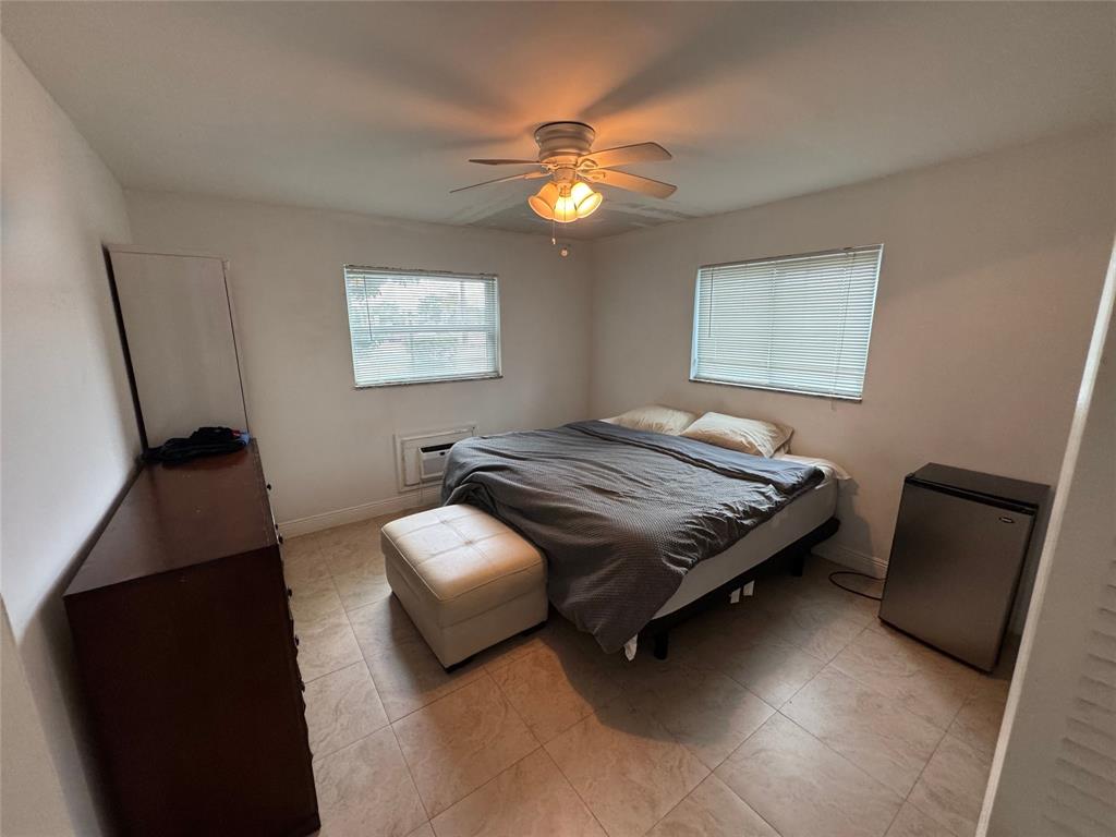 1150 East Sample Road, Unit 101 Pompano Beach, FL 33064 - Photo 11 of 17 a bedroom with a bed and window