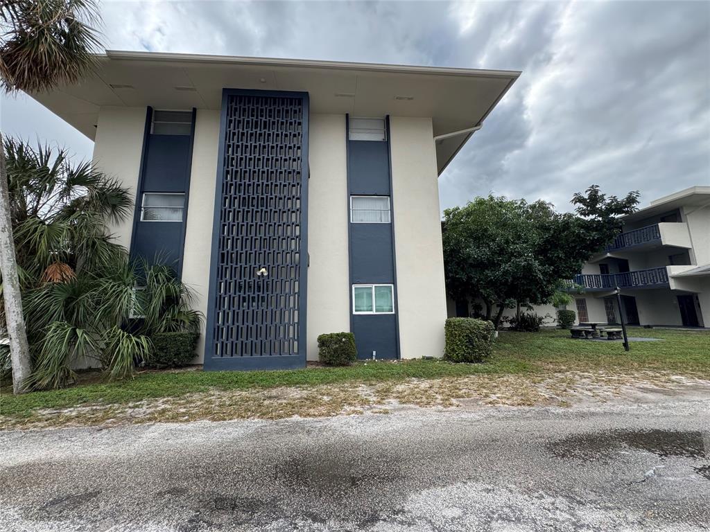 1150 East Sample Road, Unit 101 Pompano Beach, FL 33064 - Photo 17 of 17 a front view of a house with a yard