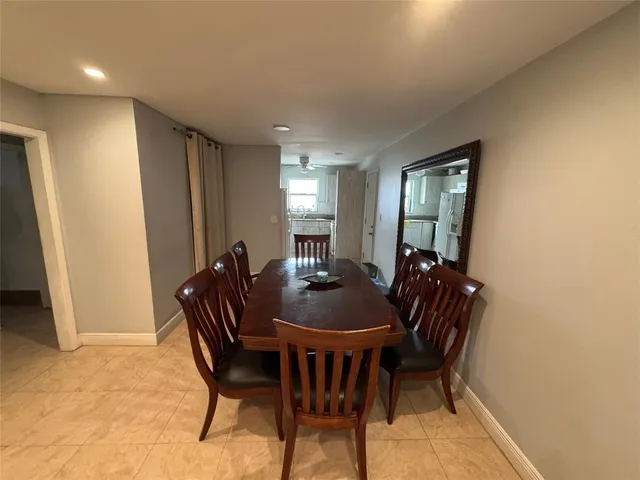a view of a dining room with furniture and window