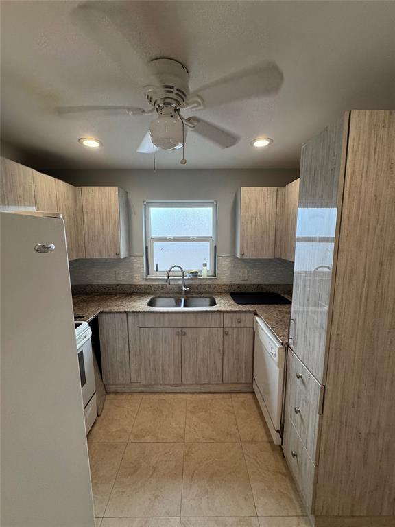 1150 East Sample Road, Unit 101 Pompano Beach, FL 33064 - Photo 5 of 17 a kitchen with a sink stainless steel appliances and cabinets