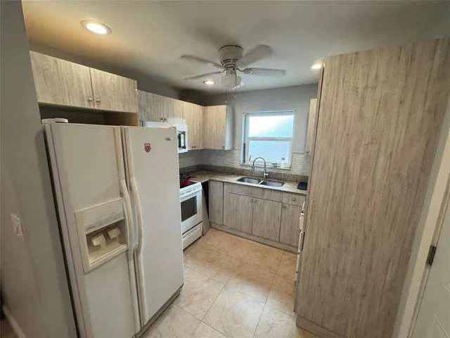 a kitchen with a refrigerator a sink and dishwasher