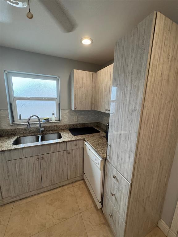1150 East Sample Road, Unit 101 Pompano Beach, FL 33064 - Photo 7 of 17 a kitchen with a sink and cabinets