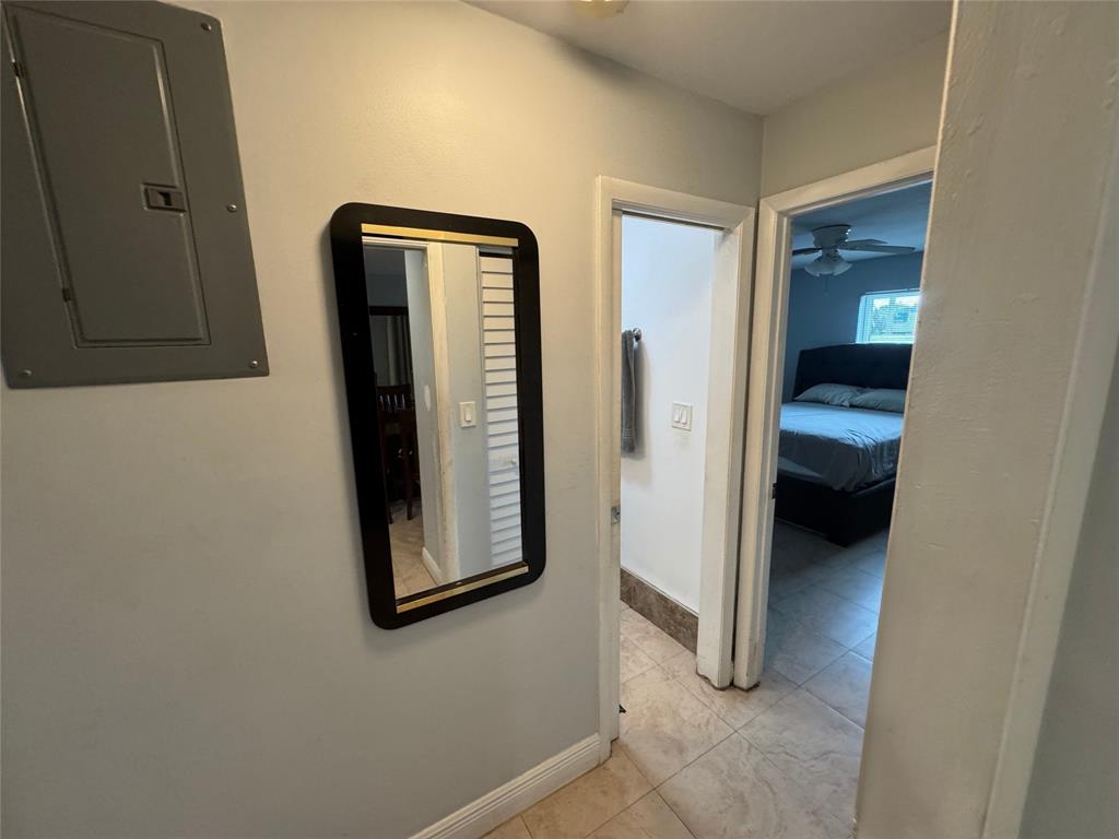 1150 East Sample Road, Unit 101 Pompano Beach, FL 33064 - Photo 9 of 17 a view of a hallway with bathroom and bathroom
