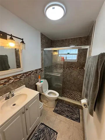 a bathroom with a sink toilet and shower