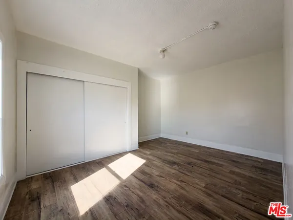 a view of an empty room and wooden floor