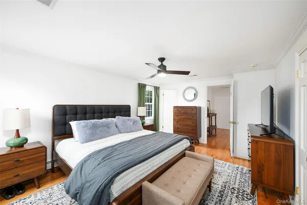 a bedroom with bed tv and fireplace