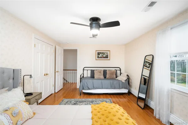 a bedroom with furniture and a wooden floor