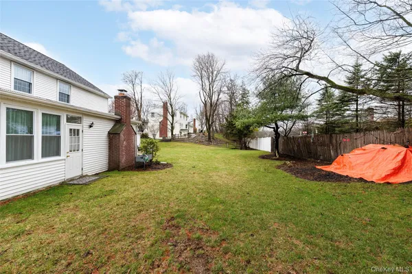 a view of a house with backyard and sitting area