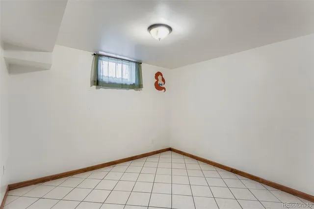 a view of an empty room and wooden floor