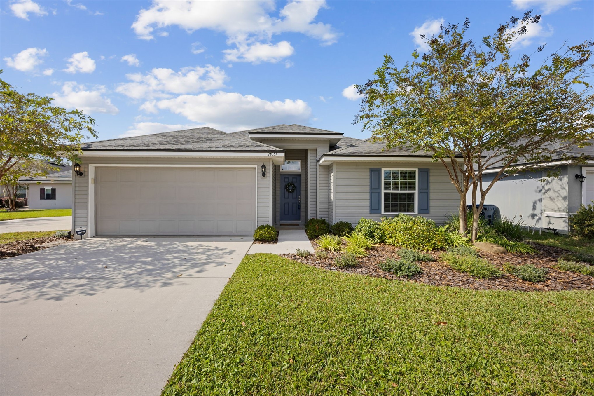 94037 Last Lane Yulee, FL 32097 - Photo 1 of 38 a front view of house with yard
