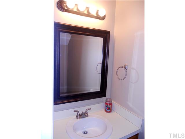 4617 Hershey Court Raleigh, NC 27613 - Photo 4 of 13 Half bath on first floor has upgraded light and sink fixtures