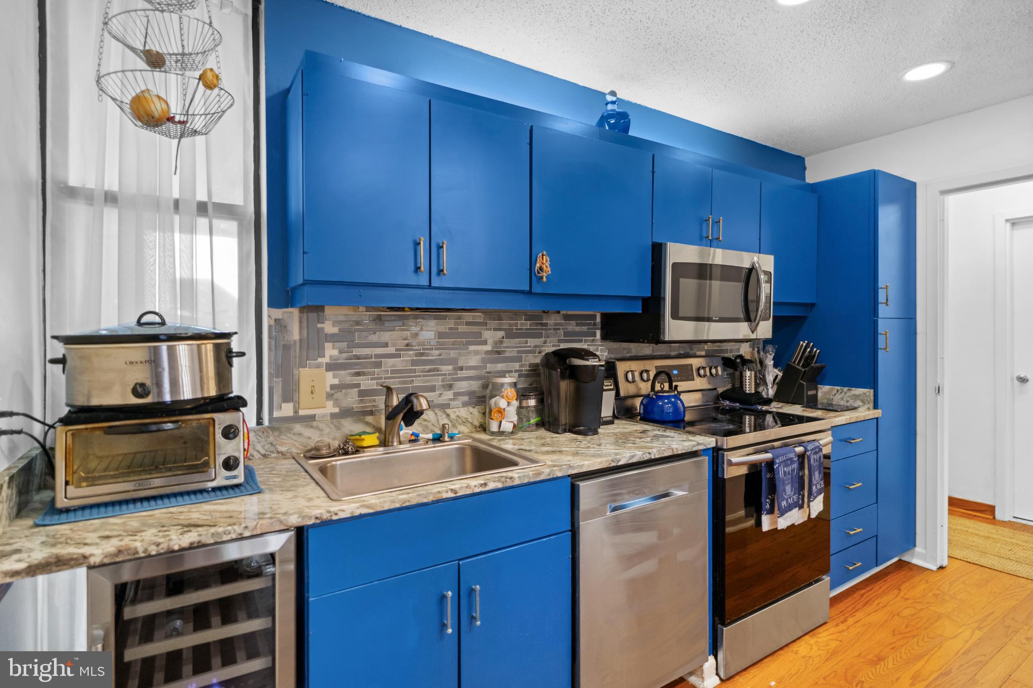 2363 Nutmeg Terrace Baltimore, MD 21209 - Photo 4 of 29 a kitchen with stainless steel appliances granite countertop a stove a sink and a microwave