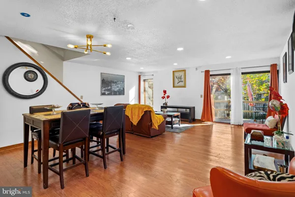 a living room with furniture and kitchen view