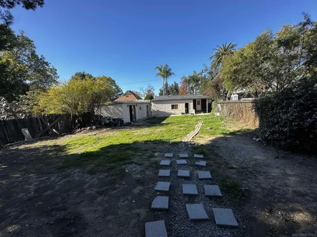 a bedroom with a bed and a chandelier fan