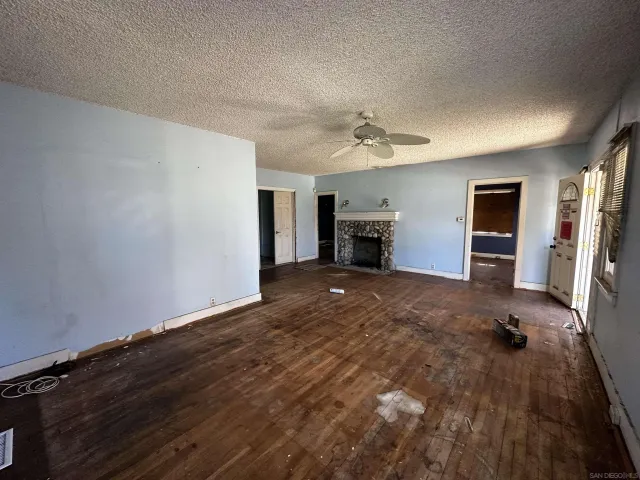 a view of empty room with a fireplace