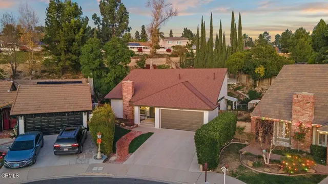 a aerial view of a house with garden and houses
