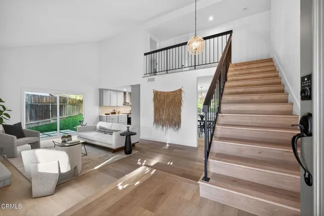a living room with furniture and stairs