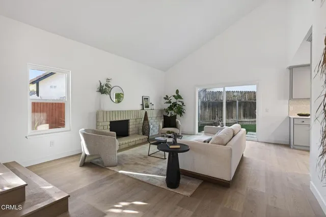 a living room with furniture a fireplace and a table