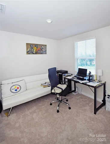 a living room with furniture and a hard wood floor