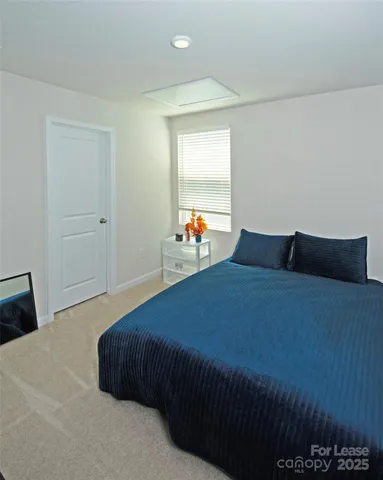 a bedroom with a bed and window