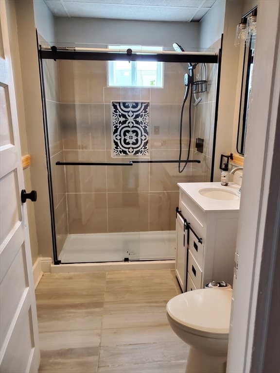 25 Kimberly Avenue, Unit 2 Springfield, MA 01108 - Photo 11 of 19 a bathroom with a sink and mirror with toilet