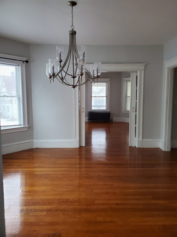 25 Kimberly Avenue, Unit 2 Springfield, MA 01108 - Photo 4 of 19 a view of a room with wooden floor window and a kitchen view