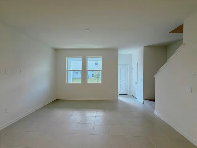 an empty room with a empty space and windows