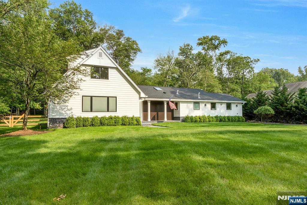a view of a yard in front of a house with a large tree
