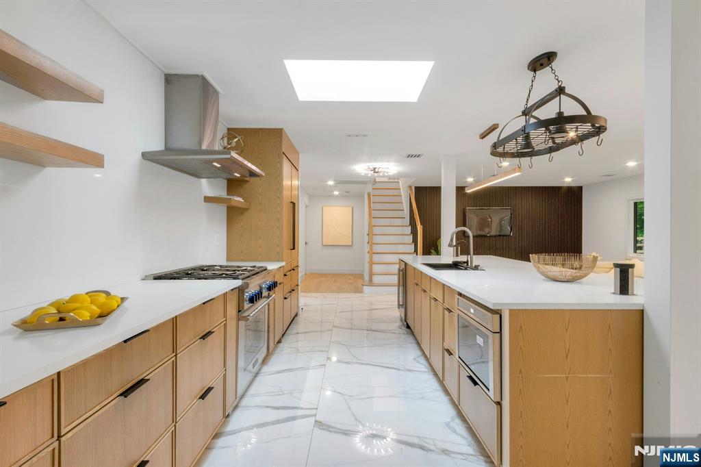 14 Rambling Brook Road Upper Saddle River, NJ 07458 - Photo 16 of 40 a kitchen with granite countertop a sink and a stove