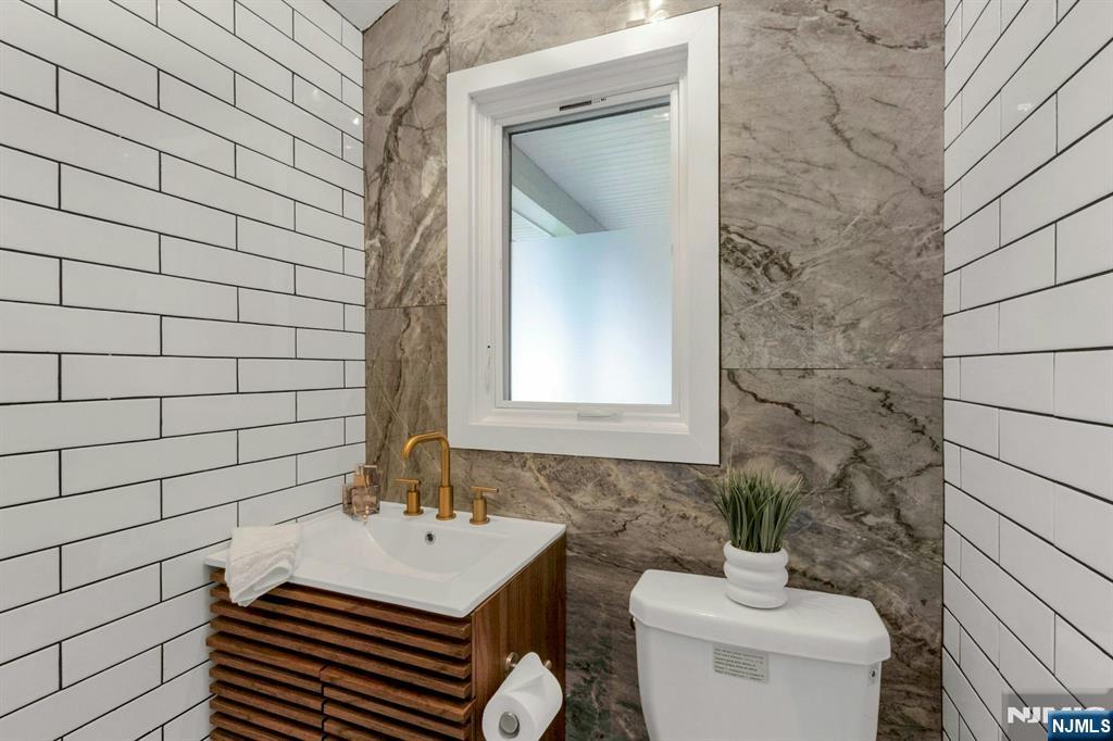 14 Rambling Brook Road Upper Saddle River, NJ 07458 - Photo 18 of 40 a bathroom with a sink and a toilet