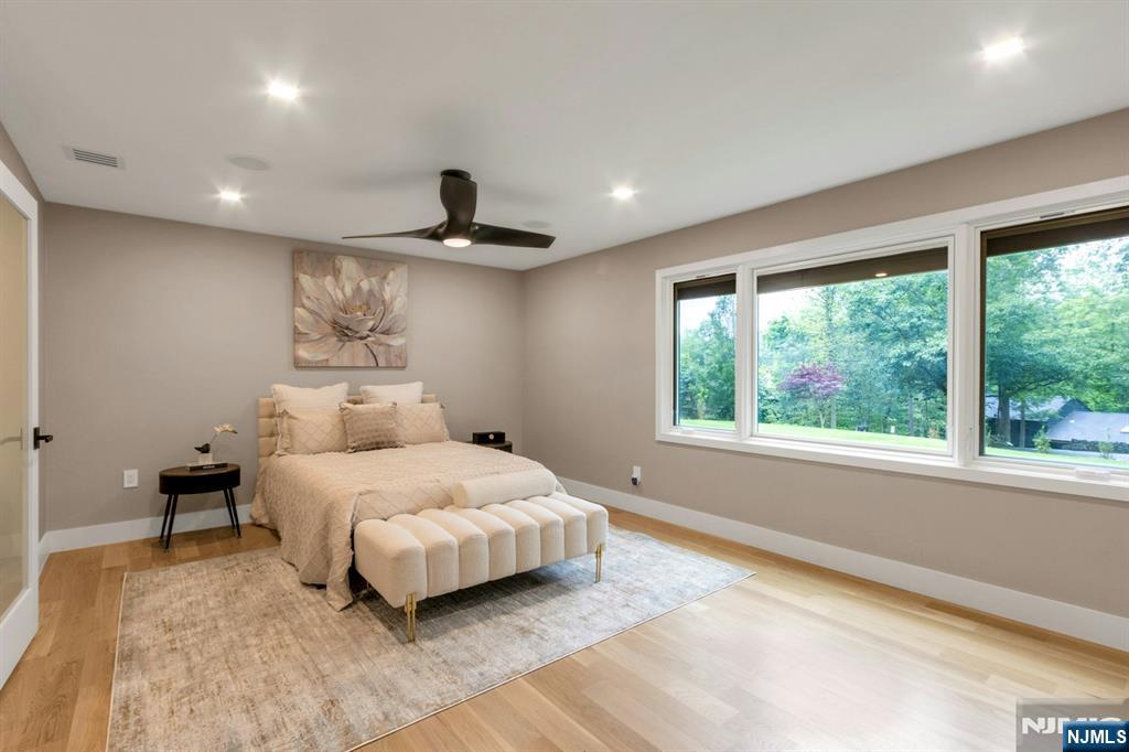 14 Rambling Brook Road Upper Saddle River, NJ 07458 - Photo 19 of 40 a bedroom with a large bed and a large window