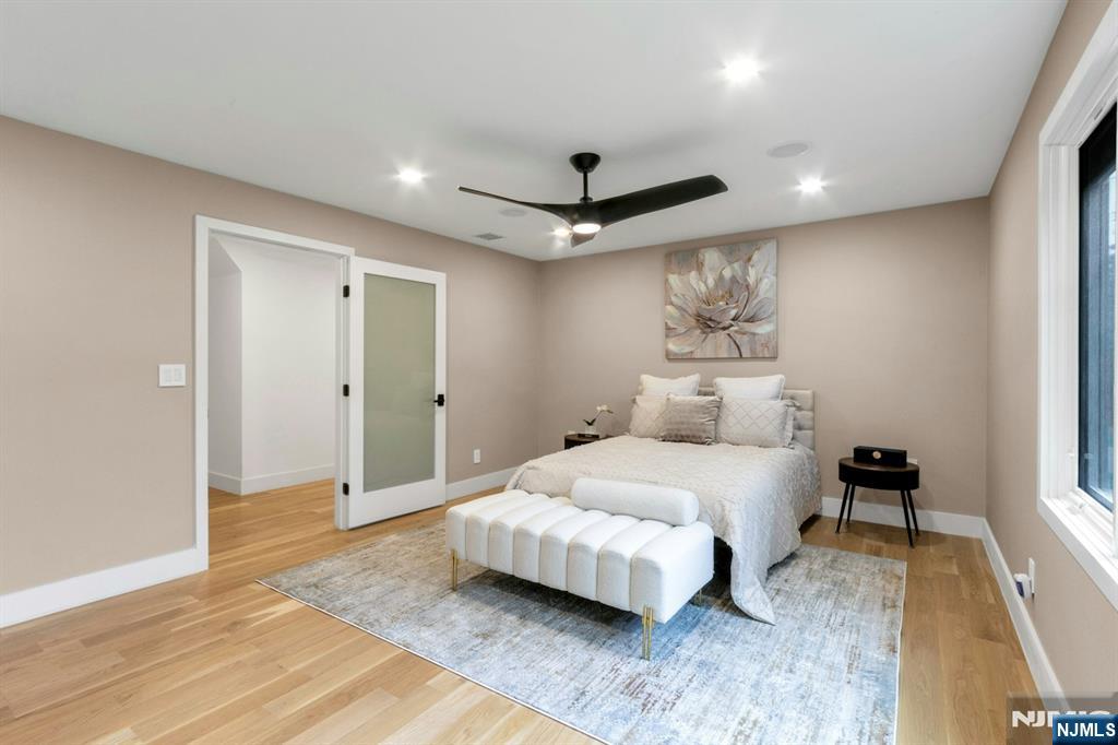 14 Rambling Brook Road Upper Saddle River, NJ 07458 - Photo 21 of 40 a spacious bedroom with a bed and a chandelier