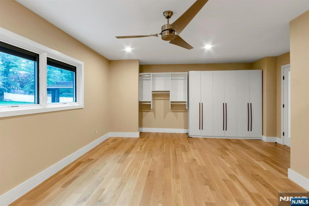 14 Rambling Brook Road Upper Saddle River, NJ 07458 - Photo 26 of 40 a view of empty room with wooden floor and fan