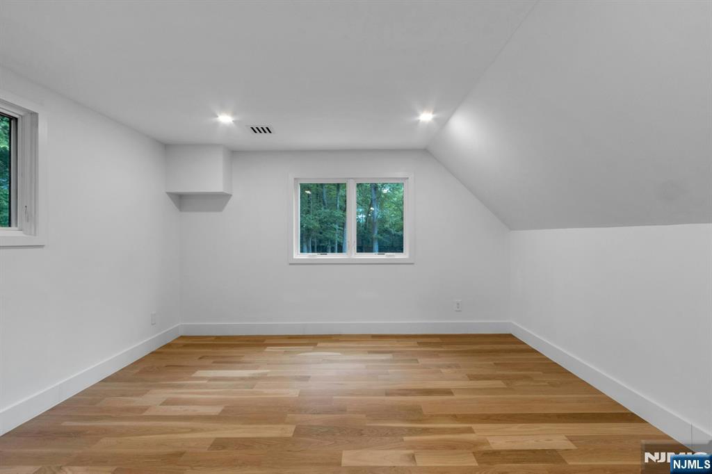 14 Rambling Brook Road Upper Saddle River, NJ 07458 - Photo 28 of 40 an empty room with wooden floor and windows