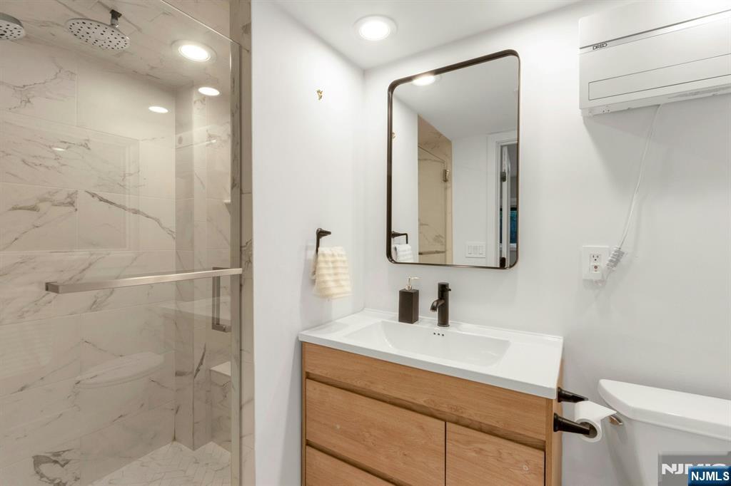 14 Rambling Brook Road Upper Saddle River, NJ 07458 - Photo 30 of 40 a bathroom with a sink vanity mirror and toilet