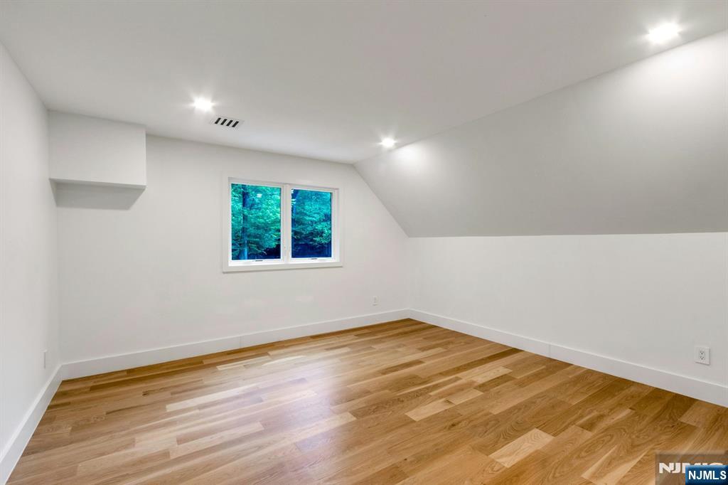 14 Rambling Brook Road Upper Saddle River, NJ 07458 - Photo 31 of 40 an empty room with wooden floor and windows