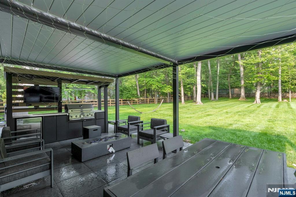 14 Rambling Brook Road Upper Saddle River, NJ 07458 - Photo 37 of 40 a living room with furniture and a garden