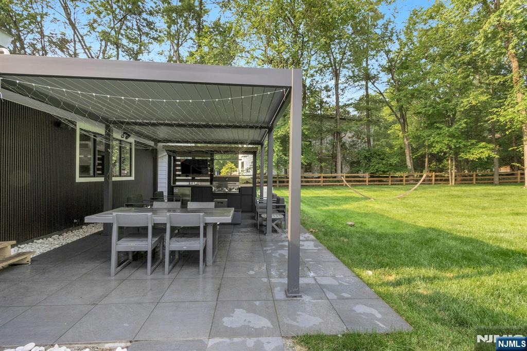 14 Rambling Brook Road Upper Saddle River, NJ 07458 - Photo 38 of 40 a view of a patio with table and chairs potted plants and large tree
