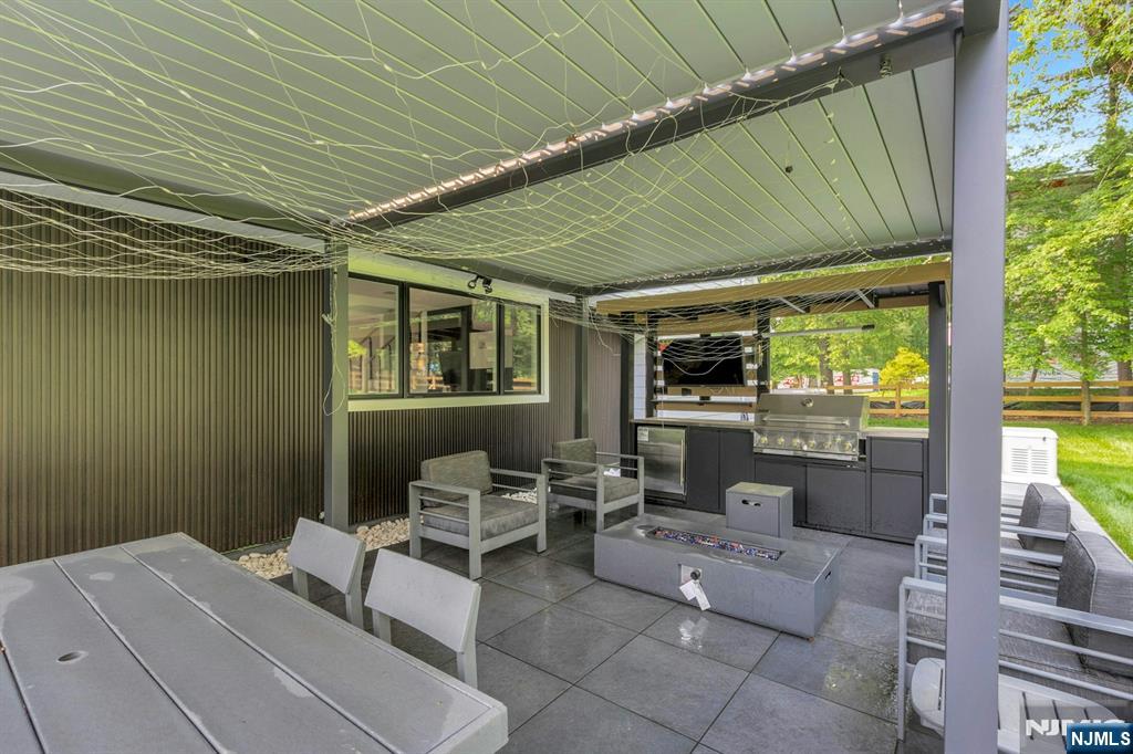 14 Rambling Brook Road Upper Saddle River, NJ 07458 - Photo 39 of 40 a outdoor space with the couches and dining table with the garden view