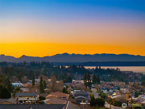 a view of a town with mountains in the background