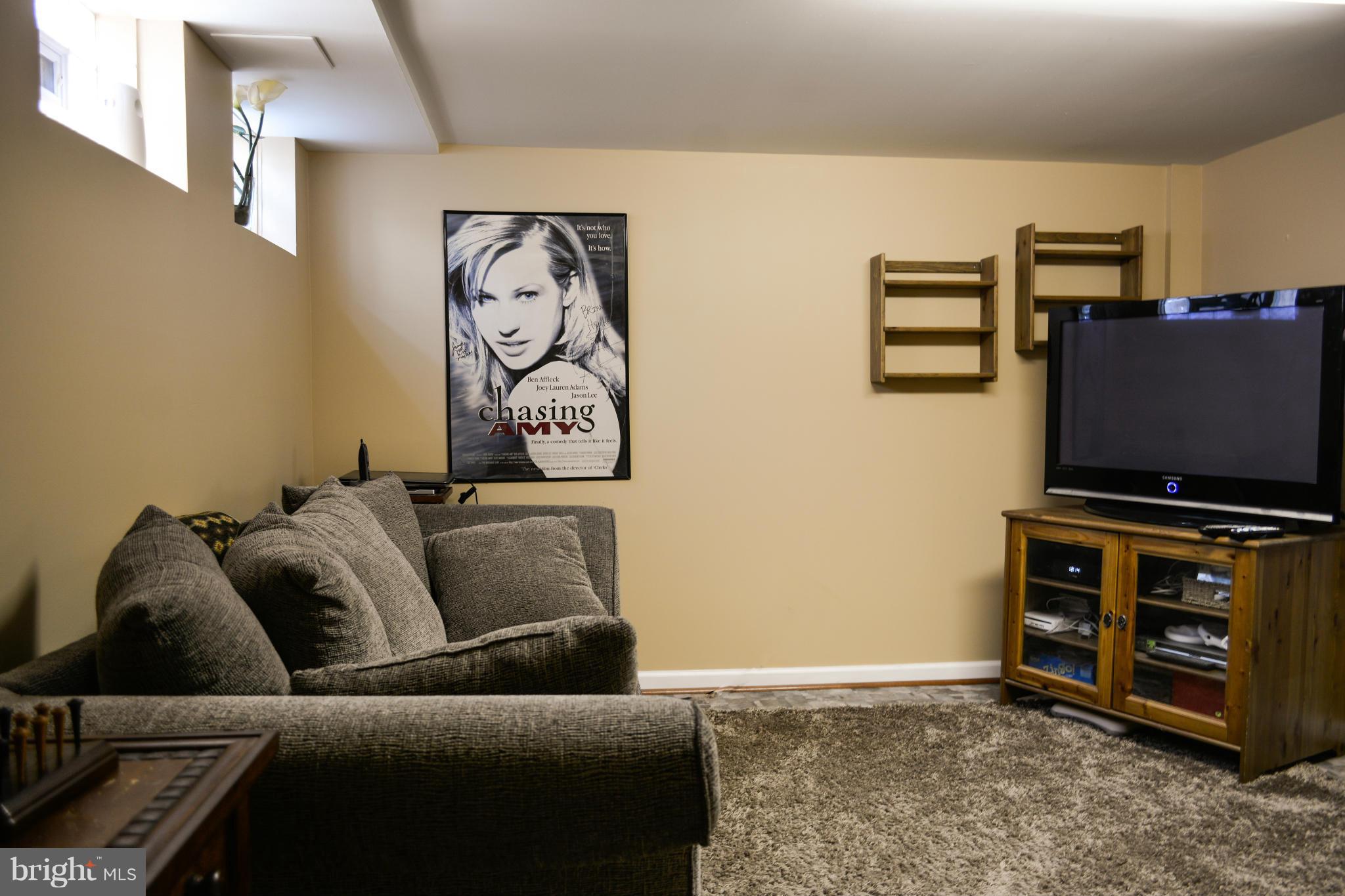 1604 Loch Ness Road Baltimore, MD 21286 - Photo 21 of 26 a living room with furniture and a flat screen tv