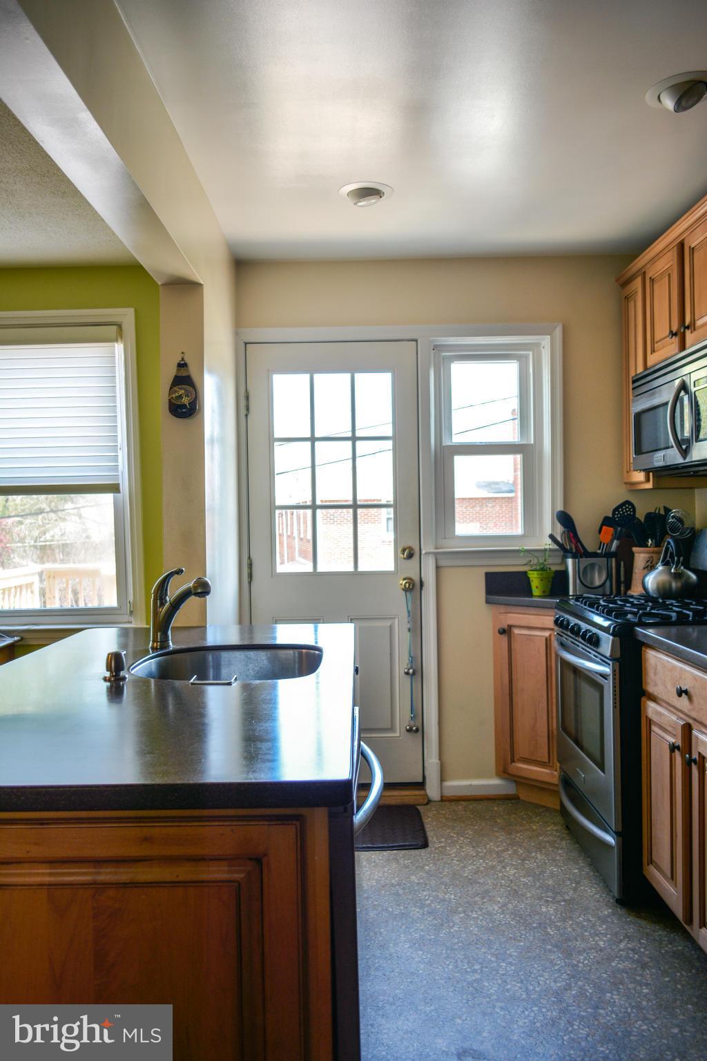1604 Loch Ness Road Baltimore, MD 21286 - Photo 6 of 26 a kitchen with a sink stove and cabinets