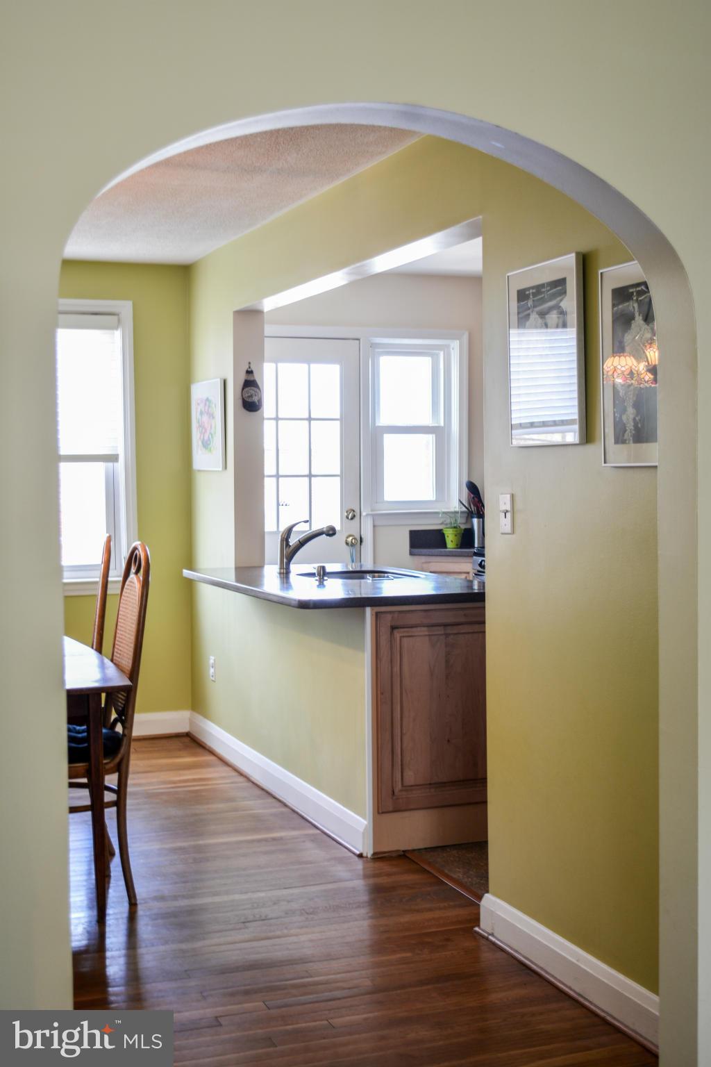 1604 Loch Ness Road Baltimore, MD 21286 - Photo 10 of 26 a kitchen with granite countertop wooden floors and wide window