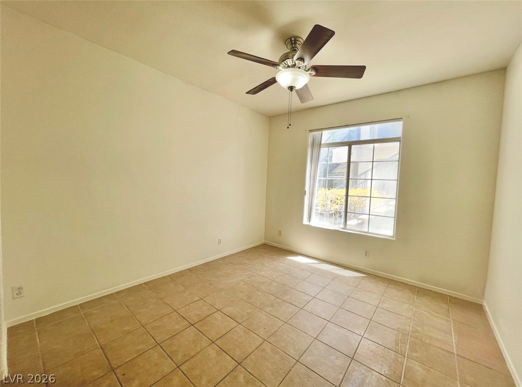 2201 Ramsgate Drive, Unit 915 Henderson, NV 89074 - Photo 34 of 36 Naturally illuminated by a large window, this bedroom offers ample space and a cooling ceiling fan.