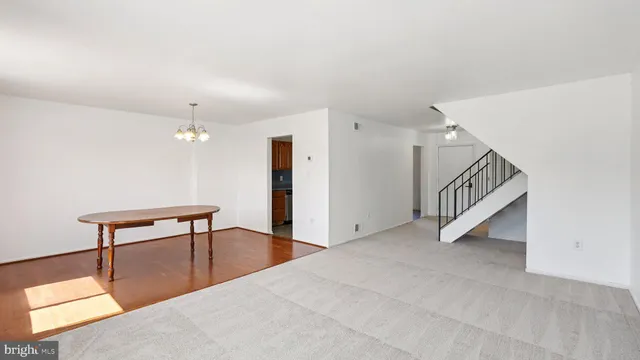 a view of a livingroom with furniture and stairs