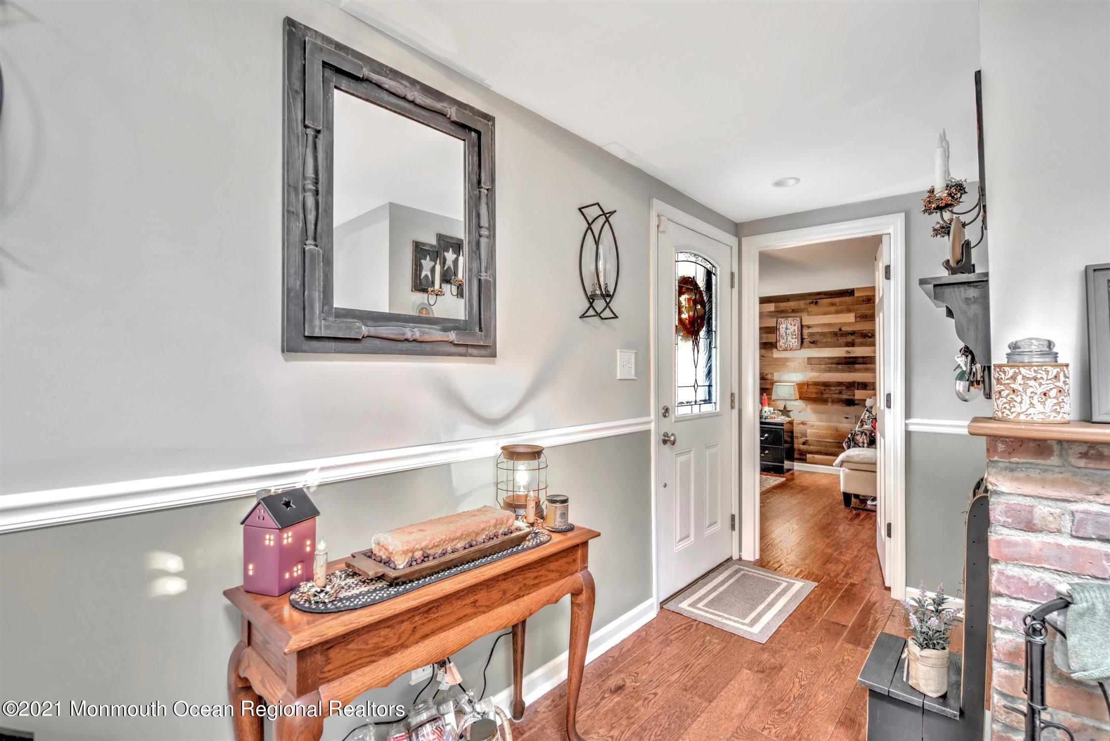 412 Conifer Drive Forked River, NJ 08731 - Photo 2 of 37 a hallway with a book shelf
