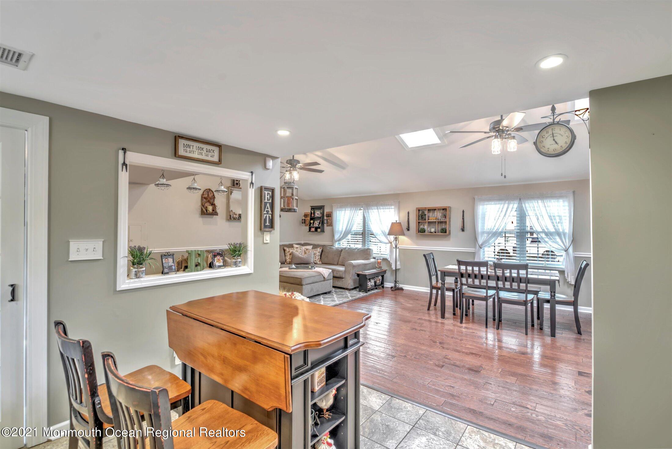 412 Conifer Drive Forked River, NJ 08731 - Photo 14 of 37 a view of a dining room with furniture window and wooden floor
