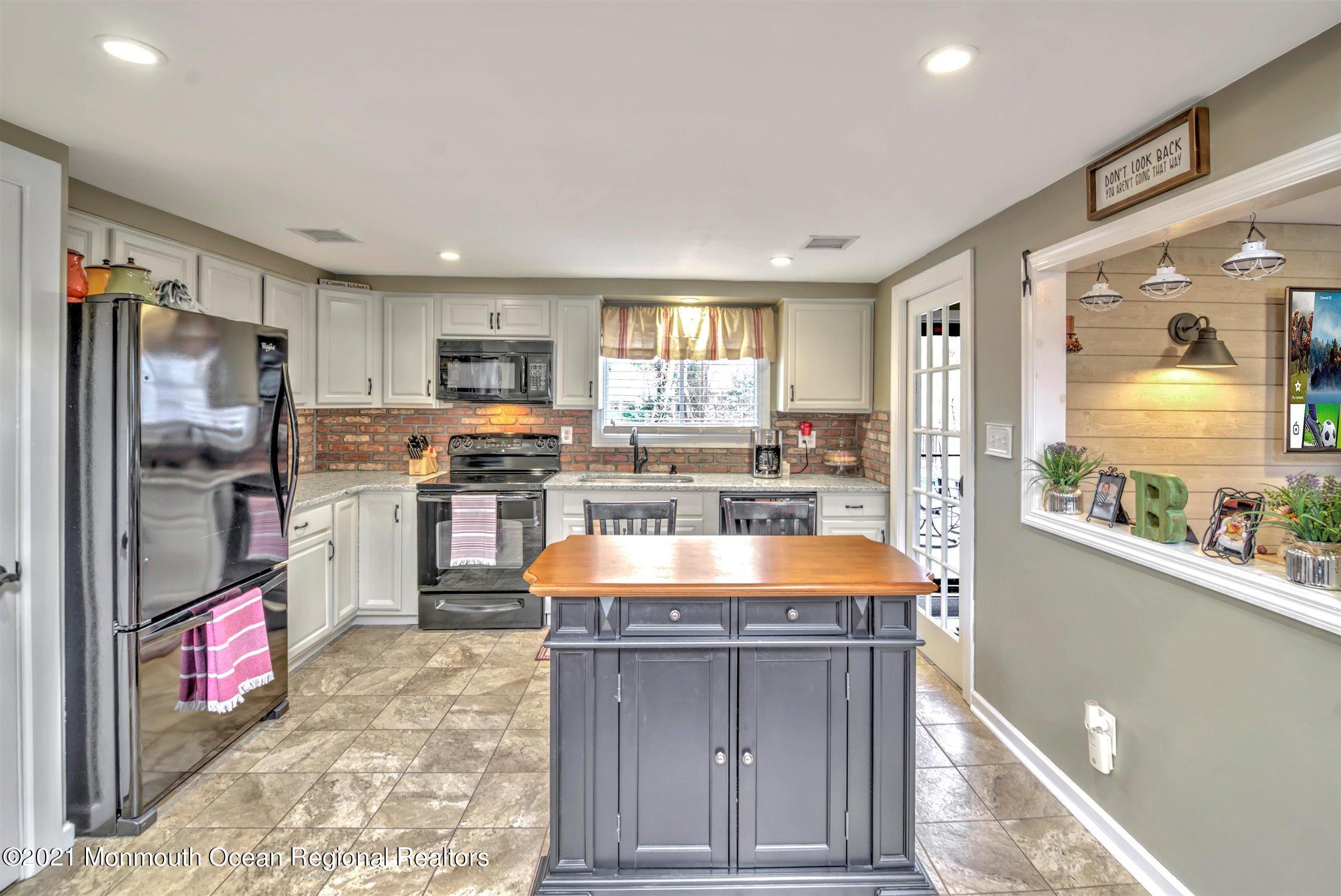 412 Conifer Drive Forked River, NJ 08731 - Photo 17 of 37 a kitchen with stainless steel appliances granite countertop a refrigerator and a stove